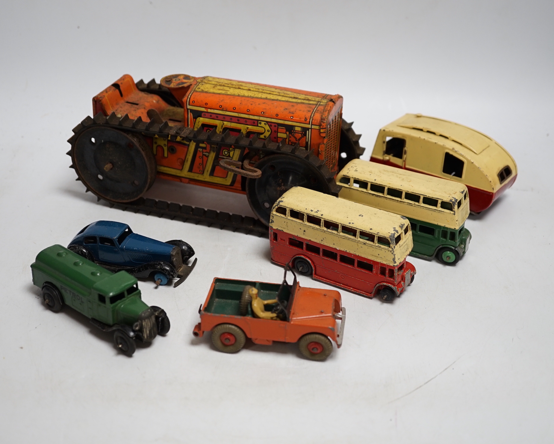 Twenty Dinky toys for restoration, including a Hudson Sedan, Loudspeaker van, Double deck Bus, Vanguard, etc. together with a Marx tinplate tractor crawler and a Tri-ang Minic caravan